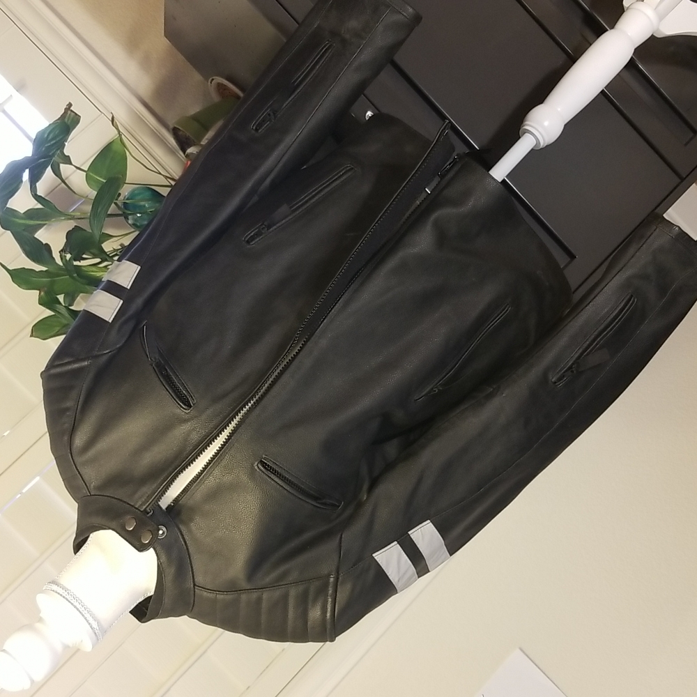 Black motor cycle jacket. Never worn. Heavy duty, black leather.